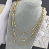 "Layered gold-plated necklaces styled for a trendy bohemian look."