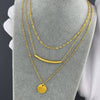 "Close-up of a necklace pendant’s intricate detailing and durable gold-plated finish."