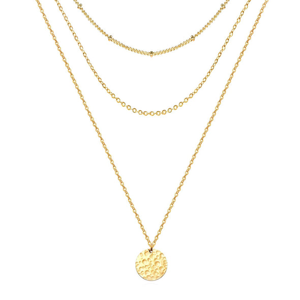 Gold-plated necklace with a pendant, photographed on a jewelry display stand.