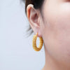 "Model wearing lightweight gold-plated earrings, perfect for both casual and formal occasions in Australia."