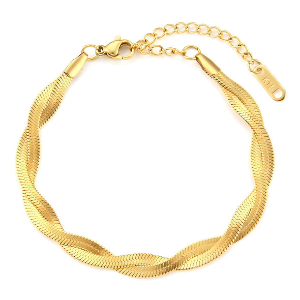 "Flat lay of a gold-plated bracelet paired with other matching gold-plated pieces."