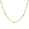 Close-up of a gold-plated necklace featuring a shimmering cubic zirconia insert.