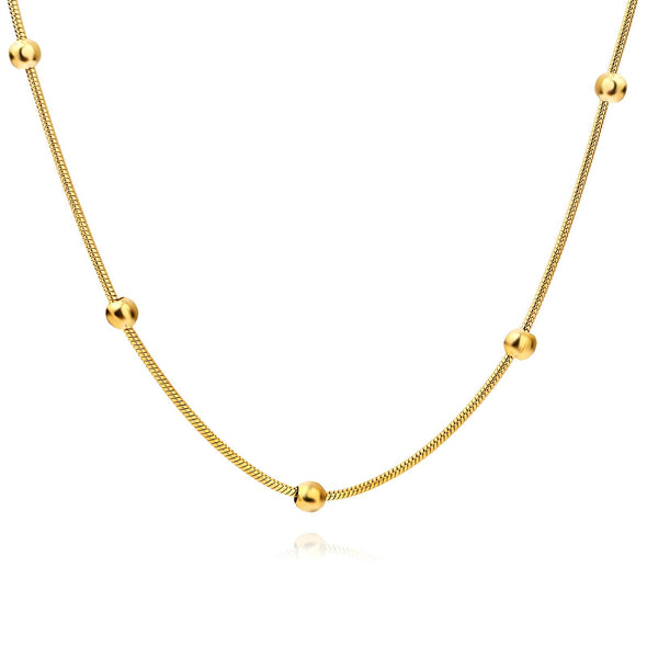 Close-up of a gold-plated necklace featuring a shimmering cubic zirconia insert.