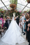 Full-length view of the ELIKA beaded lace mantilla veil draping elegantly over the bride's shoulders