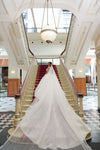 Side profile of the ELIKA cathedral veil highlighting the scalloped lace edges and shimmering beads."