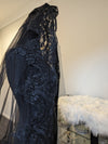 Side view of the black lace wedding veil flowing gracefully behind the bride