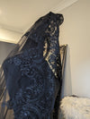 Close-up of intricate lace detailing on the Gisel black cathedral wedding veil