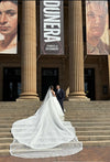 Bride wearing the ELIKA cathedral-length mantilla wedding veil with intricate beaded lace detailing.